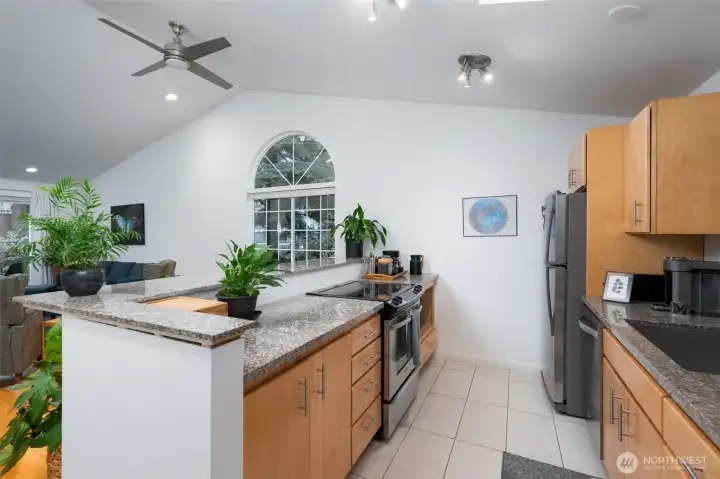 The galley kitchen offers abundant cabinet storage and is beautifully finished with granite countertops.