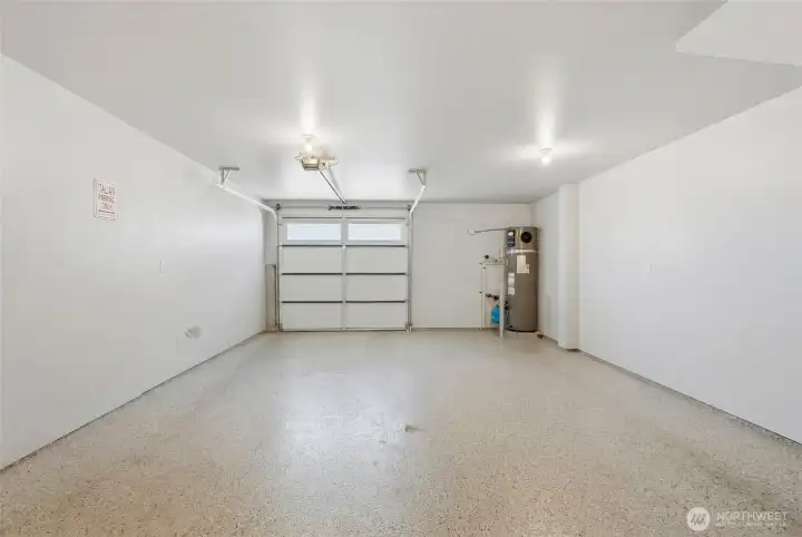 Extra-deep 2-car tandem garage upgraded  with epoxy flooring, insulation and finished  walls.
