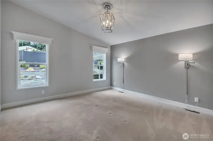Primary bedroom with upgraded lighting and looking out into the backyard