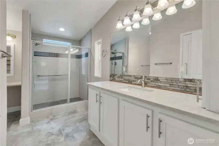Primary bathroom with 2 sinks, walk-in shower and extra vanity/prep area