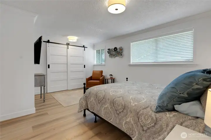 Primary bedroom has been re-imagined, more interior space with the closet just behind the modern barn doors.