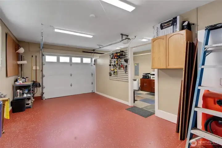 Newly coated epoxy flooring lines your garage, work from home office has been set up for your own space away to focus and stay productive during crunch time!