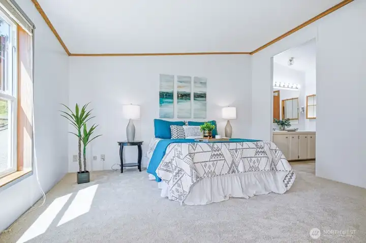 primary bedroom with bathroom beyond