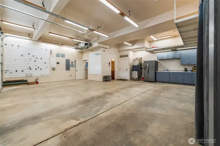 Huge garage with so many amenities including cabinets and sink and 3/4 bath!