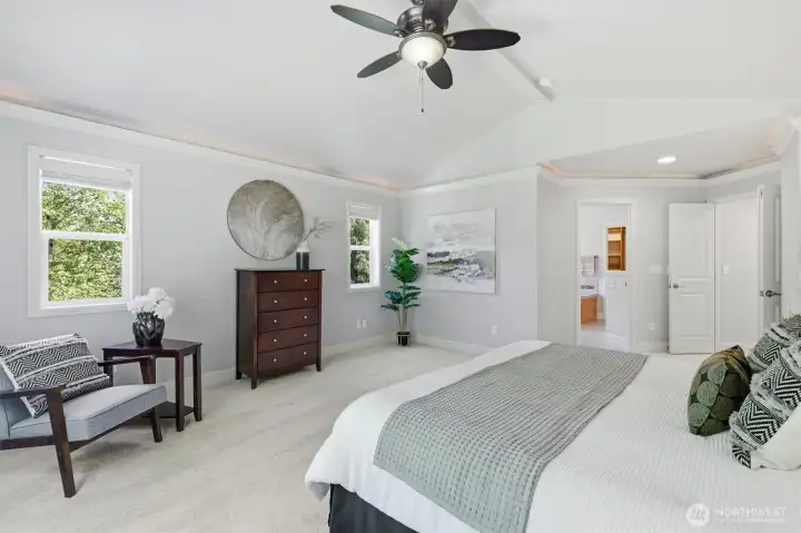 Spacious primary bedroom with vaulted ceilings