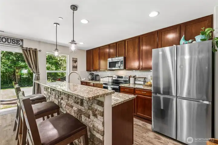 Open kitchen with granite counters, stainless appliances and dining for 3 at the island. Open kitchen with granite counters, stainless appliances and dining for 3 at the island.