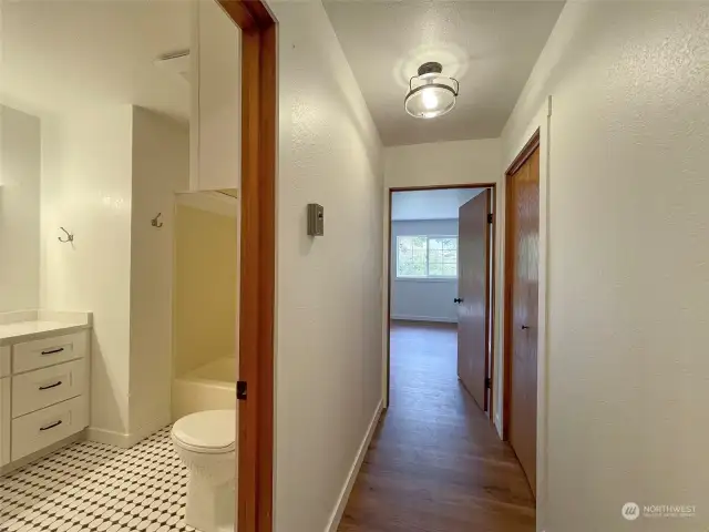 Hallway leading to the Primary Bedroom. Storage closet to the right just before entering the Primary bedroom.