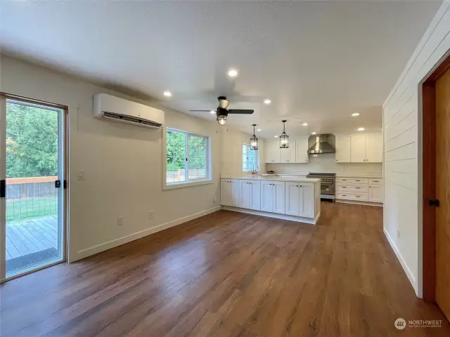 View looking from the living area to the dining room and the open kitchen.