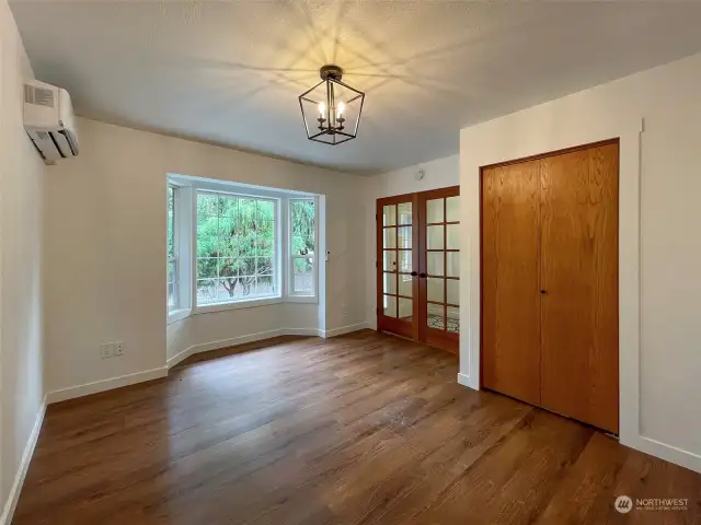 Looking towards the beautiful bay windows, french door and closet to the right.