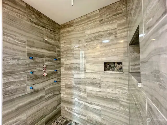 Custom tile shower with ceiling rain head & full body spray.