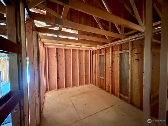 Unfinished craft room off garage with pocket door