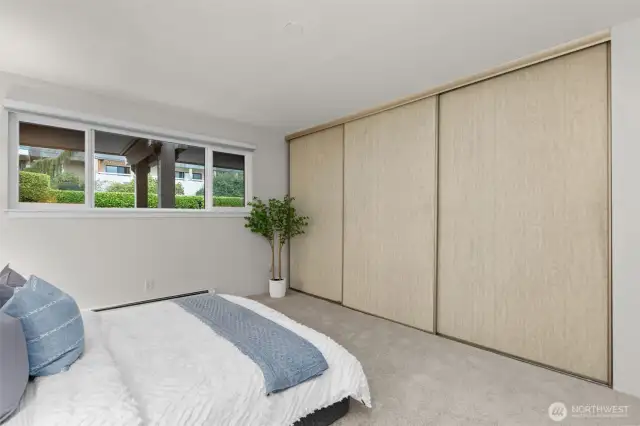 2nd bedroom featuring a wall of closets