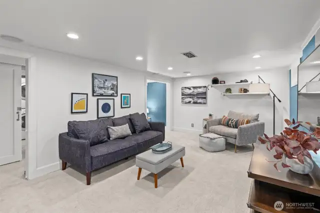 Modern barn doors on both sides of the family room add privacy for the space and bedroom.
