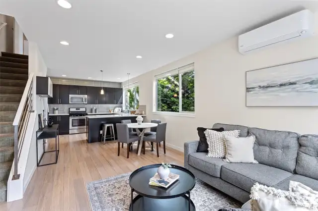 A seamless transition from the dining to the south facing kitchen with large countertops and stainless appliances.