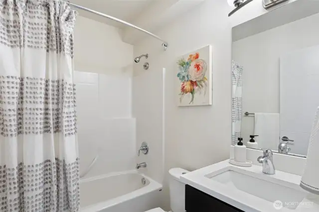 Entry level full bathroom with modern finishes.