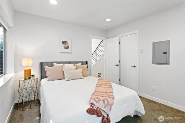 Entry level 3rd bedroom with sliding door to enclosed backyard.