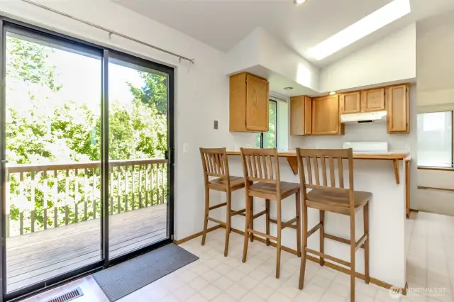 Kitchen eating area with slider to upper deck