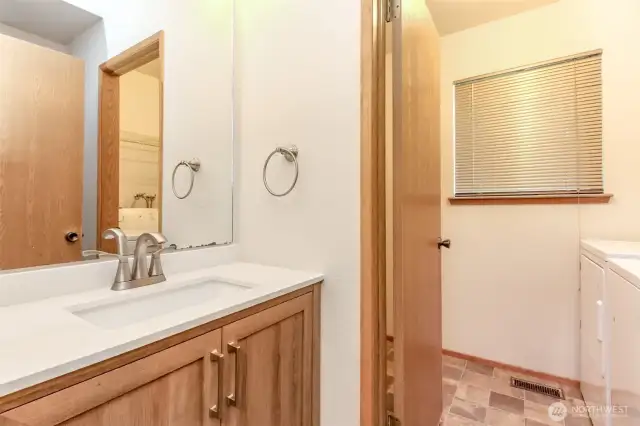 Lower level half bath and door to laundry room