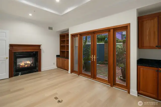 This is the floor #2 'Board' room with two-sided fireplace and french doors to the brick patio.