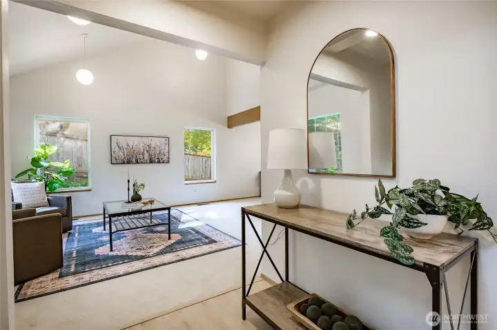 Entry flows into living room that is open to the second floor