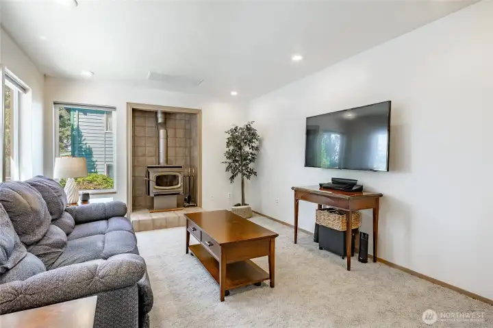 Bright cheery informal living space with fresh paint and free standing wood stove