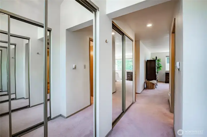 Primary bedroom dressing room with 3 closets