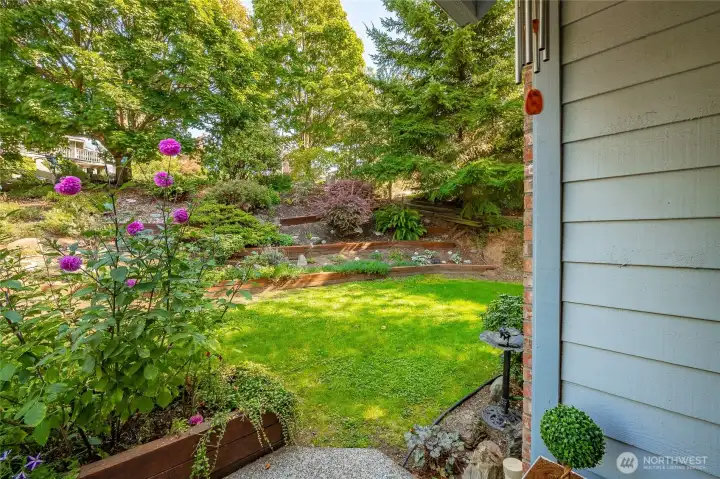 Front yard is terraced with lovely vegitation and street is tree lined