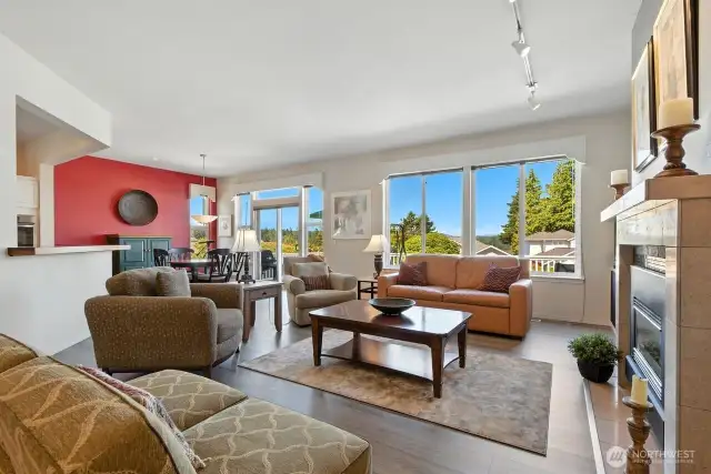 Open concept living area with large windows for an abundance of light throughout home! Engineered hardwood floors, gas fireplace.