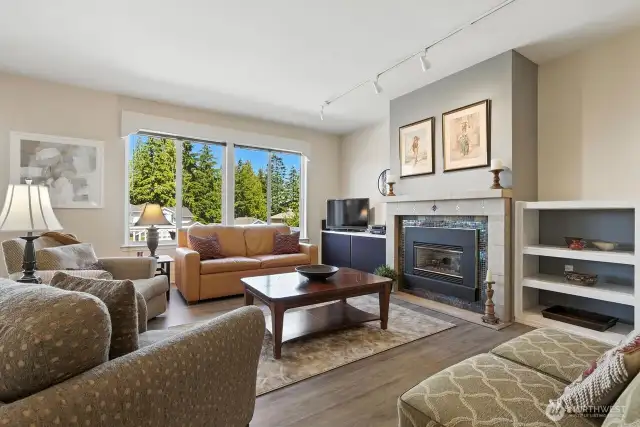 Open concept living area with large windows for an abundance of light throughout home! Engineered hardwood floors, gas fireplace.