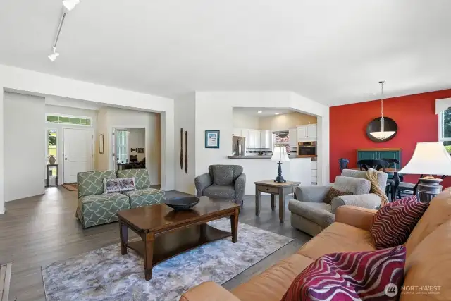 Open concept living area with a floor plan that just flows - large windows for an abundance of light throughout home! Engineered hardwood floors, gas fireplace.