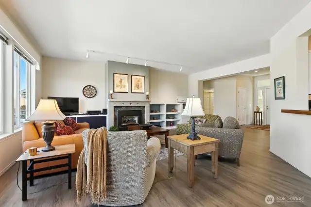 Open concept living area with a floor plan that just flows - large windows for an abundance of light throughout home! Engineered hardwood floors, gas fireplace.