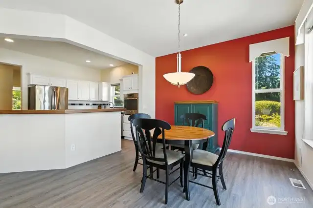 Open floor plan flows to dining area and well-appointed kitchen that invites participation
