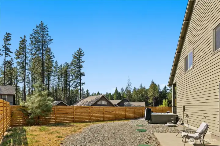 Back of home with private patio for primary bedroom