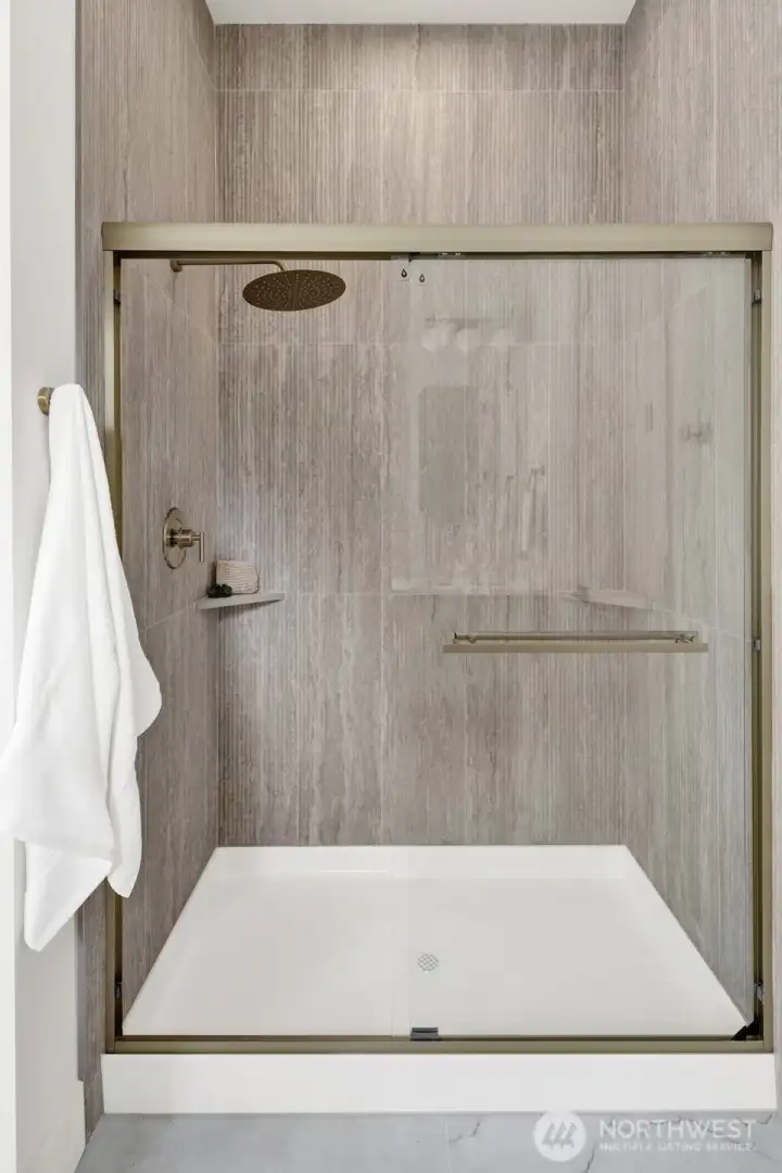The primary  bathroom also features a spacious walk-in shower