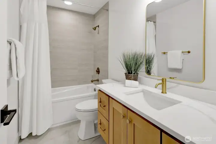 Upstairs find a full bathroom with the same high-end finishes as the rest of the home
