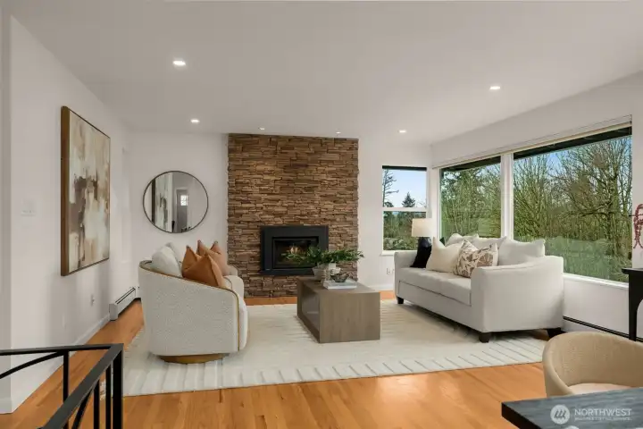 Generous Living Room with gas fireplace- large windows highlight beautiful territorial and Cascade Mountain views!