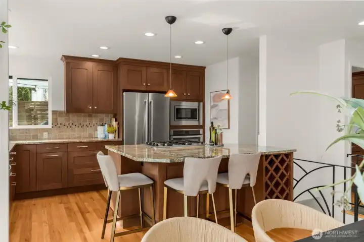 Looking towards the Kitchen- take in all that counter space and cabinetry! Corner window works well as a pass-thru to the chef working the BBQ.