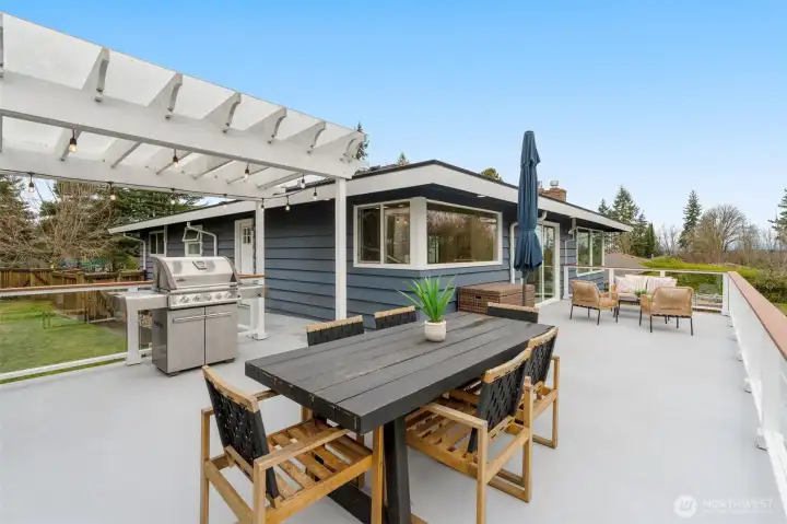 The perfect outdoor room- easily doubles your living space! Door to the Mud Room/Kitchen is around the corner from the BBQ, and corner window doubles as an easy pass-thru. Large BBQ is connected to gas line and conveys   to lucky Buyer. Deck is large enough to also accommodate a large seating area, in addition to a dining space.