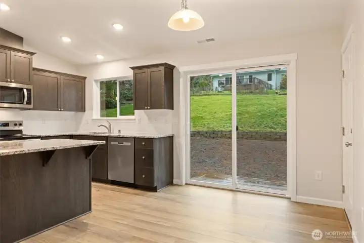 Light-filled dining area overlooking the spacious backyard with lots of room to garden and play.
