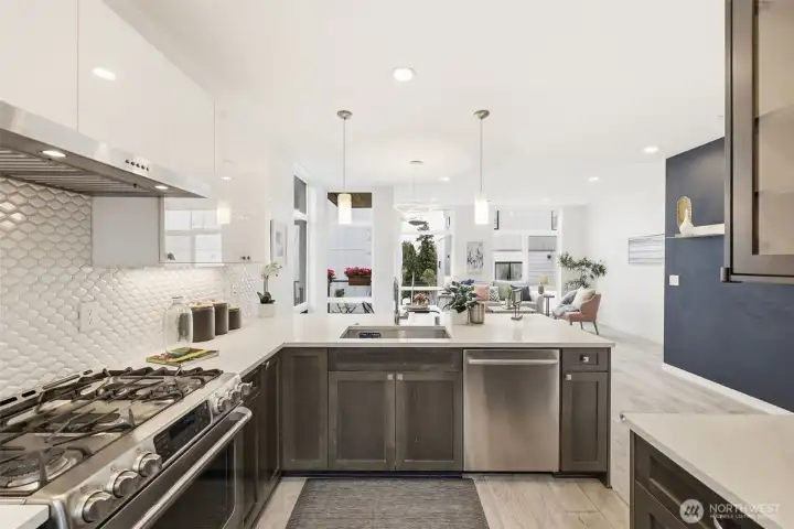 Gourmet kitchen with powerful range hood over five burner cooktop, and ultra-quiet Bosch dishwasher.
