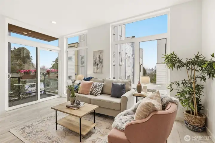 Floor-to-ceiling windows in the air conditioned living room and dining room lavish the space in light.  To the left is the deck with convenient access from the kitchen.  To the right is the view of Downtown and the Great Wheel.