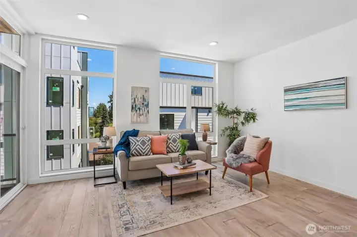 Floor-to-ceiling windows in the air conditioned living room and dining room lavish the space in light, and frame the view of Downtown and the Great Wheel.  To the left is the deck with convenient access from the kitchen.