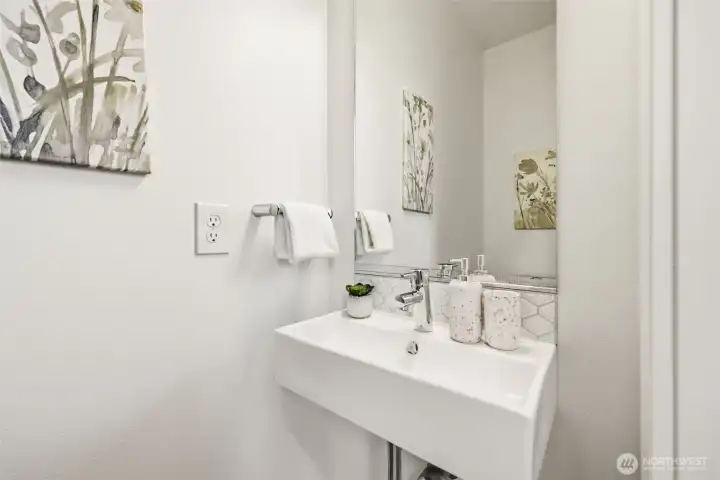 Half-bath on the 3rd level, near the kitchen, dining room and living room.