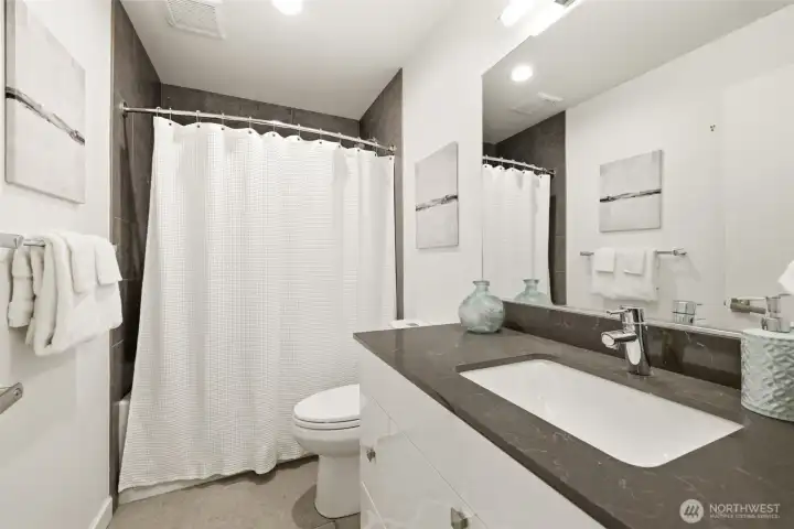 Full bath on the first level, just outside of bedrooms 2 and 3.