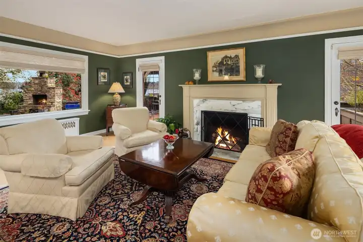 Formal living room with fireplace and french doors leading to private patio are