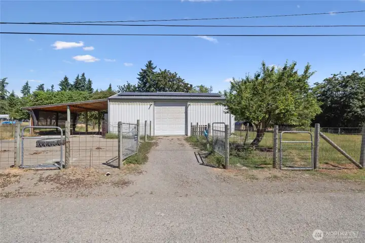 Barn- A car-charger plug is in place for added convenience. The space also features built-in livestock feeders, dedicated hay storage, and a defined pen area with durable concrete flooring. Cross-fencing completes the setup.