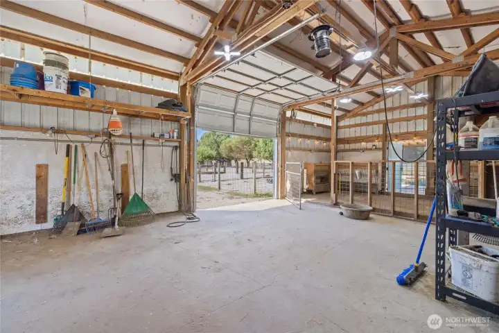 Barn- A car-charger plug is in place for added convenience. The space also features built-in livestock feeders, dedicated hay storage, and a defined pen area with durable concrete flooring. Cross-fencing completes the setup.