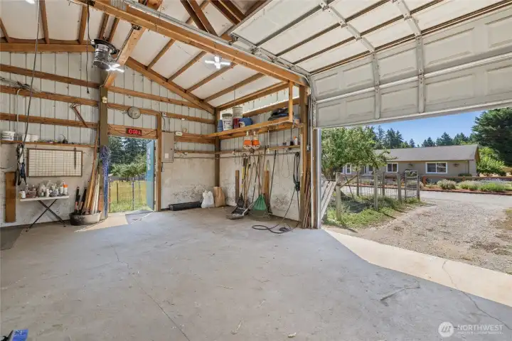 Barn- A car-charger plug is in place for added convenience. The space also features built-in livestock feeders, dedicated hay storage, and a defined pen area with durable concrete flooring. Cross-fencing completes the setup.