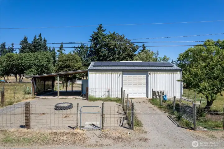 Barn- A car-charger plug is in place for added convenience. The space also features built-in livestock feeders, dedicated hay storage, and a defined pen area with durable concrete flooring. Cross-fencing completes the setup.