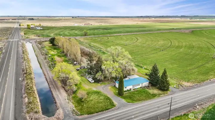 Double-wide manufactured home with three bedrooms and two bathrooms, and a hazel nut orchard with water rights, right next to the canal on the corner of Rd E and 9. AS IS, but will clean up real good!